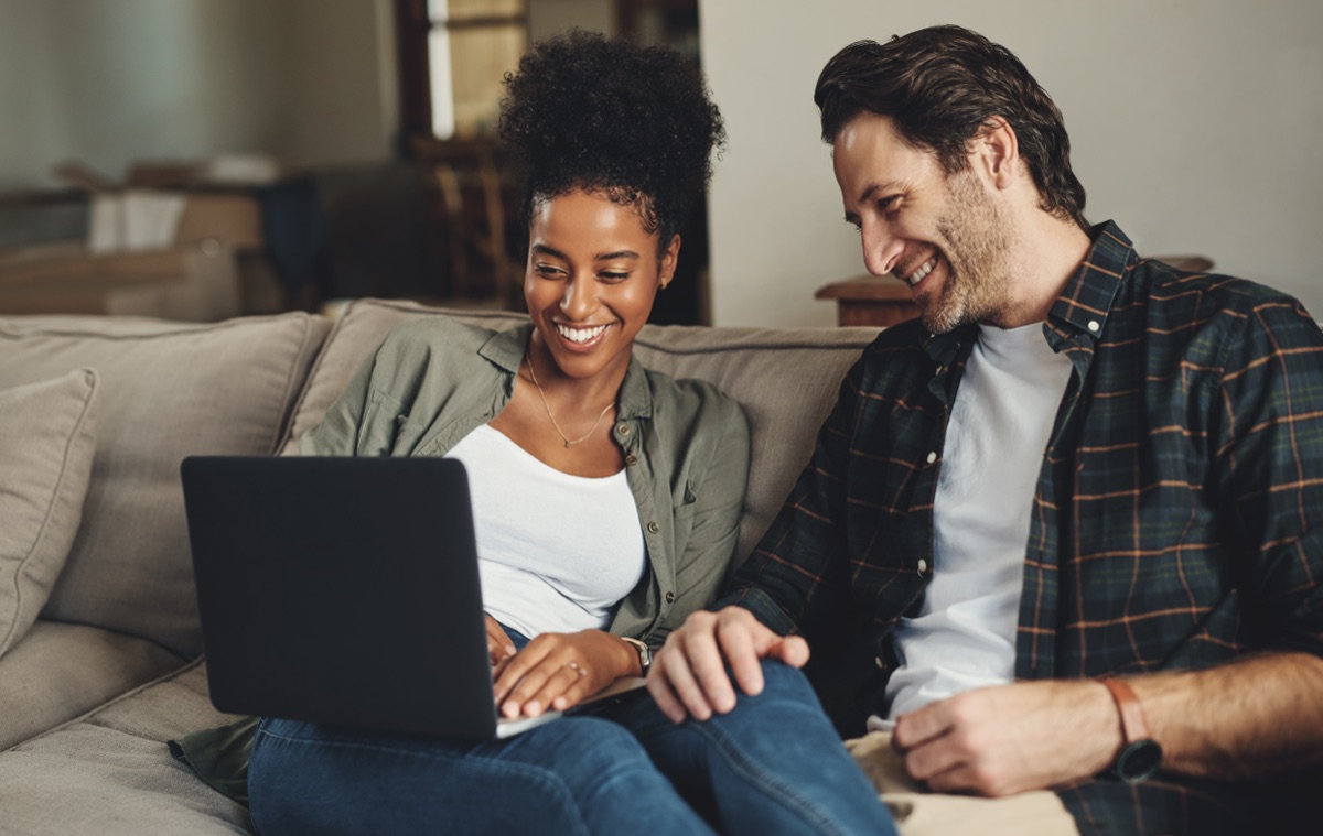 A couple sitting together, smiling